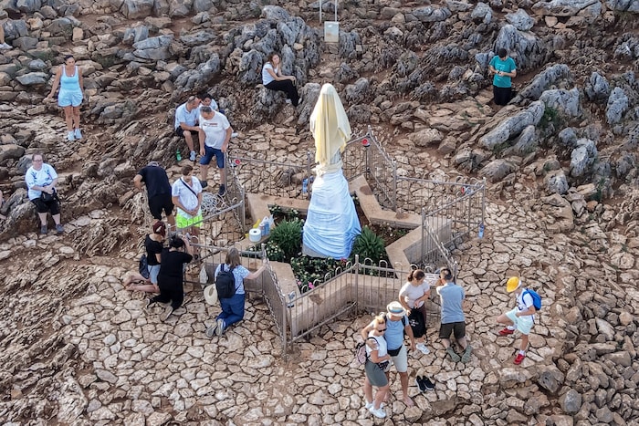 Dutzende Gläubige versammelten sich bei der bedeckten Statue zum Rosenkranzgebet