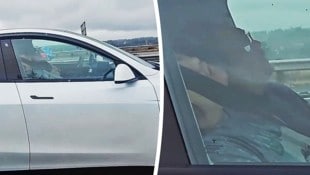 Fahrer und Beifahrer vertrauen komplett auf die Technik und schlafen, während ihr Auto von ...