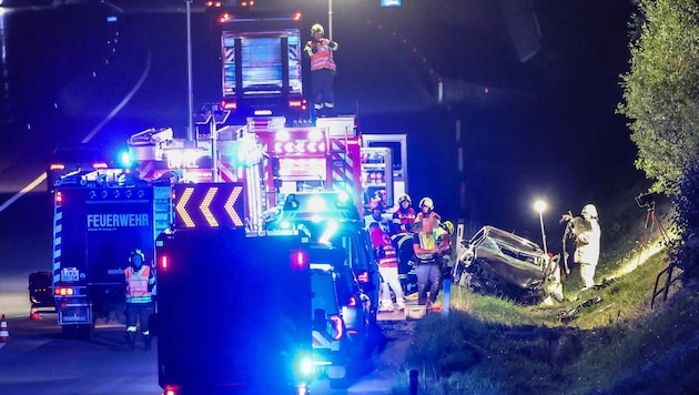The severely damaged car came to rest beside the highway