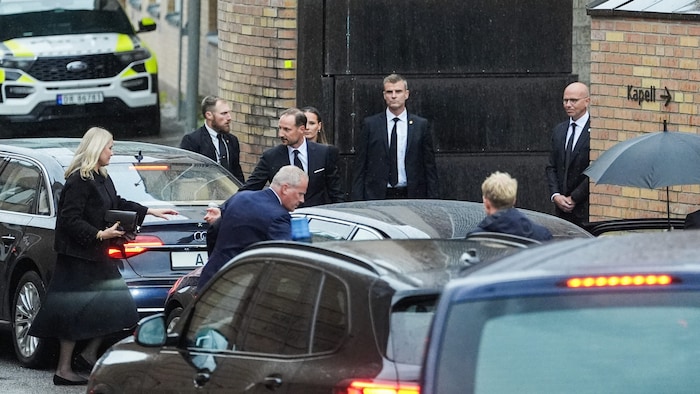 King Haakon extends his hand to Queen Mette-Marit.