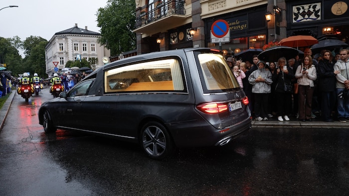 Mourners line the streets.