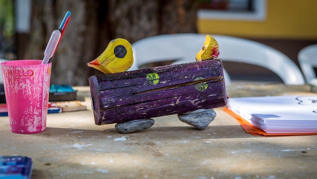 Kinder haben farbenfrohe Holz-Enten gestaltet, die sich am Mühlbach ein Rennen liefern – der ...