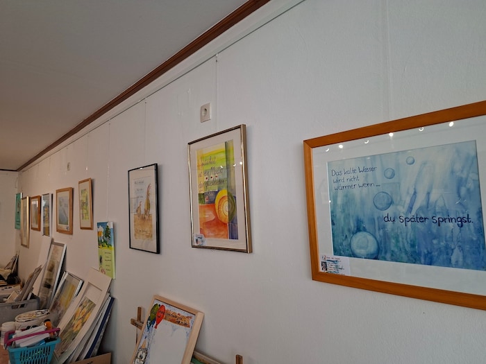 An der Wand des Ateliers hängen und stehen Arbeiten.