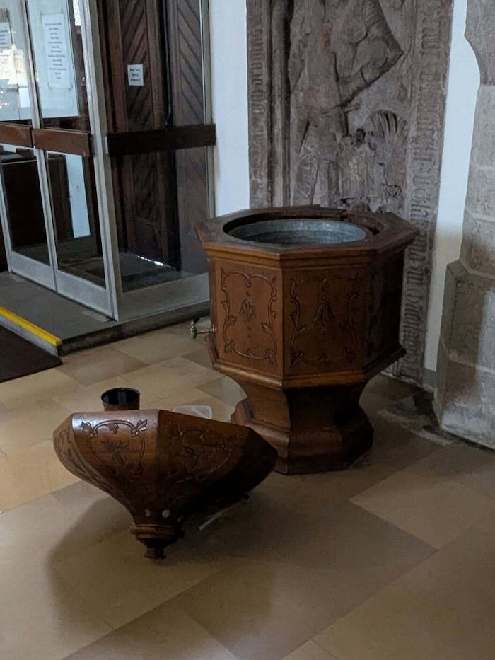 The lid of the holy water font was torn off.