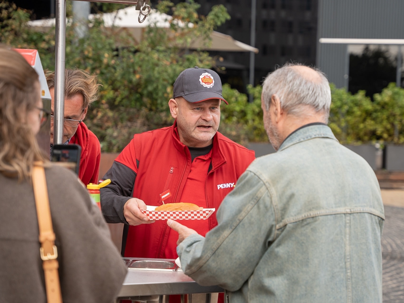 Das PENNY Team versorgt die Passant:innen mit frischen Hotdogs.