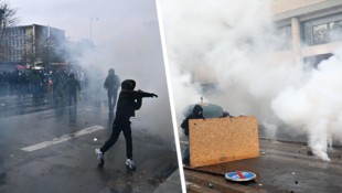 Während in Frankreichs Hauptstadt Tränengas aufsteigt, verstecken sich Protestierende hinter ...