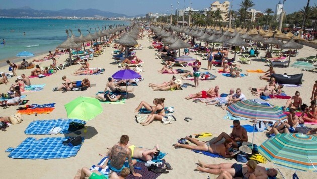 Touristen an einem Strand auf Mallorca (Bild: AFP)