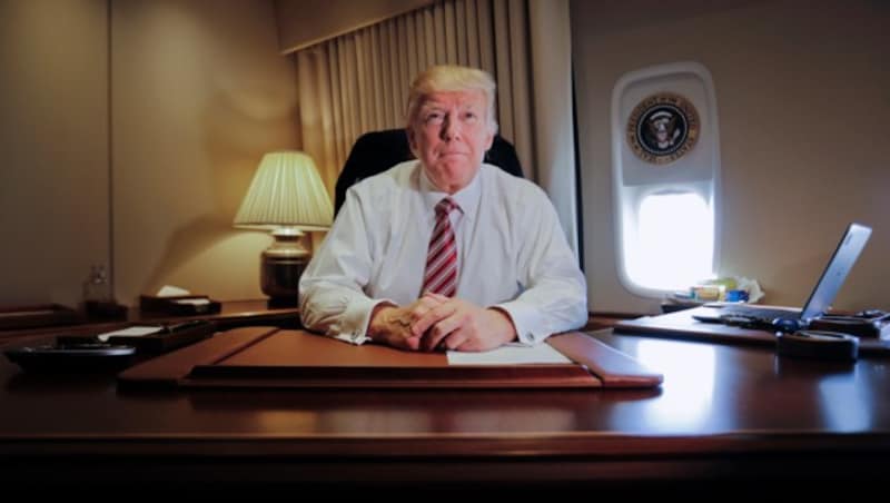 Trump hinter seinem Schreibtisch in der Air Force One (Bild: Associated Press)