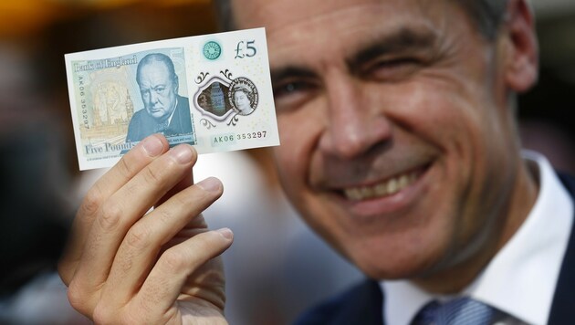 Großbritanniens Notenbankchef Mark Carney mit dem neuen Fünfer (Bild: APA/AFP/POOL/STEFAN WERMUTH)