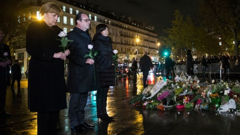 Kanzlerin Merkel, Präsident Hollande und Bürgermeisterin Hidalgo gedenken der Opfer. (Bild: AP)