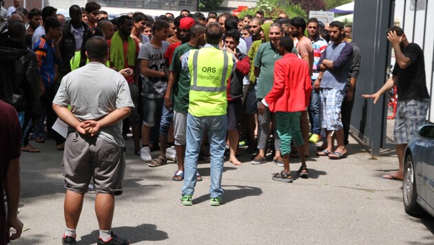 Mehr als hundert Asylwerber drängen sich beim Tor zum Linzer Polizeisportverein. (Bild: Christoph Gantner)