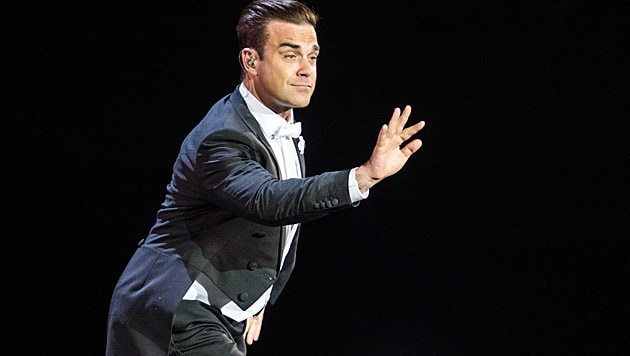 Robbie Williams plaudert während eines Konzertes aus: "Es wird ein Bub!" (Bild: APA/EPA/FERDY DAMMAN)